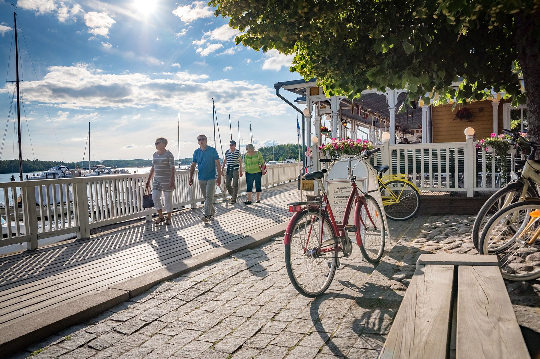 Visitors walk beside the guest harbour in Naantali, lined with restaurants.