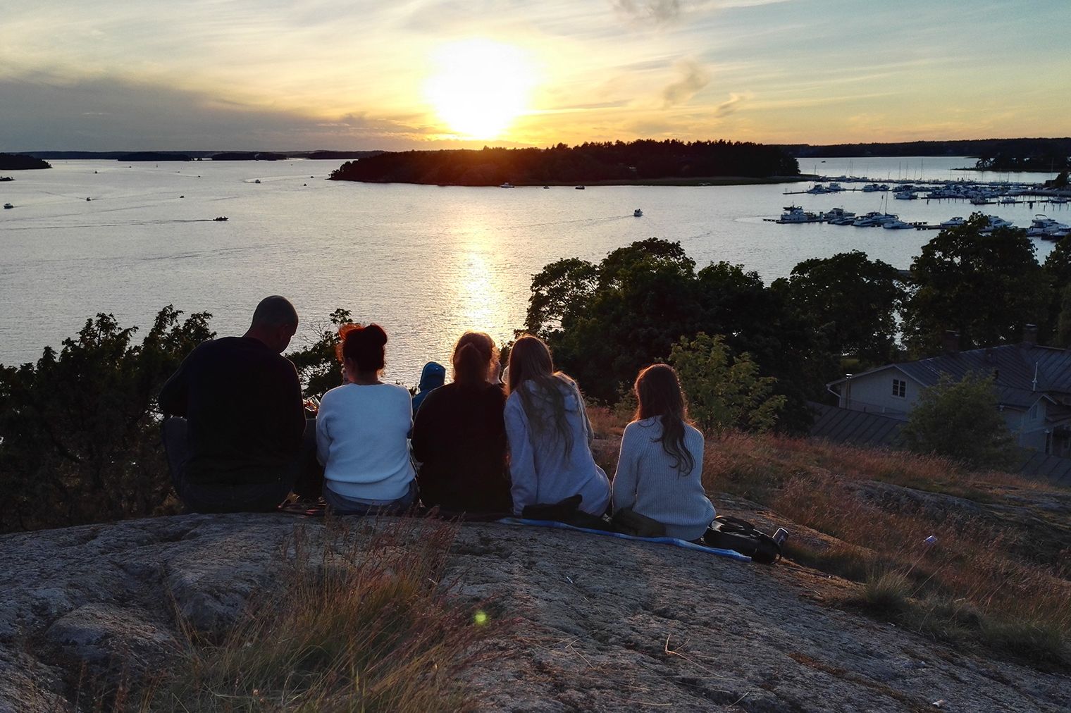 Visitors watch the sunset from Kuparivuori Hill in Naantali.