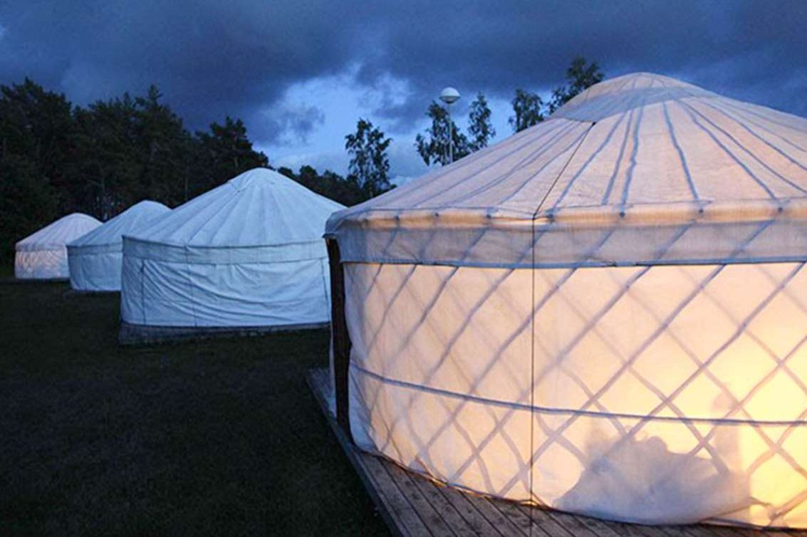 A row of white-coloured yurts at Lootholma.